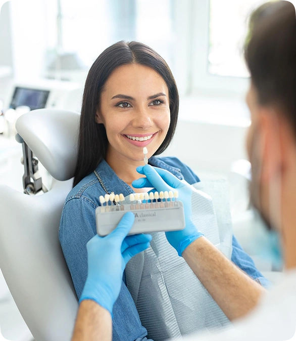 Dental implant consultation with patient reviewing tooth shade options for a natural smile result