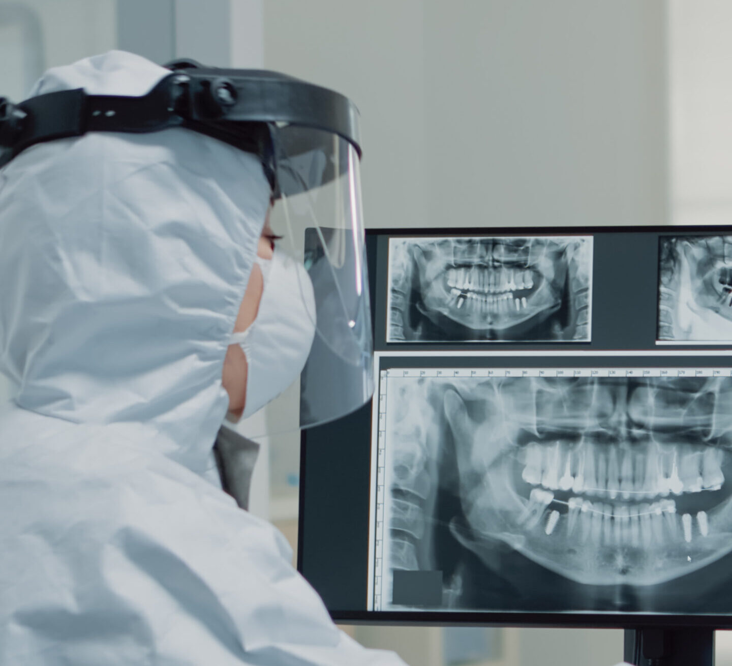 A dentist analysing gaps between teeth of a patient