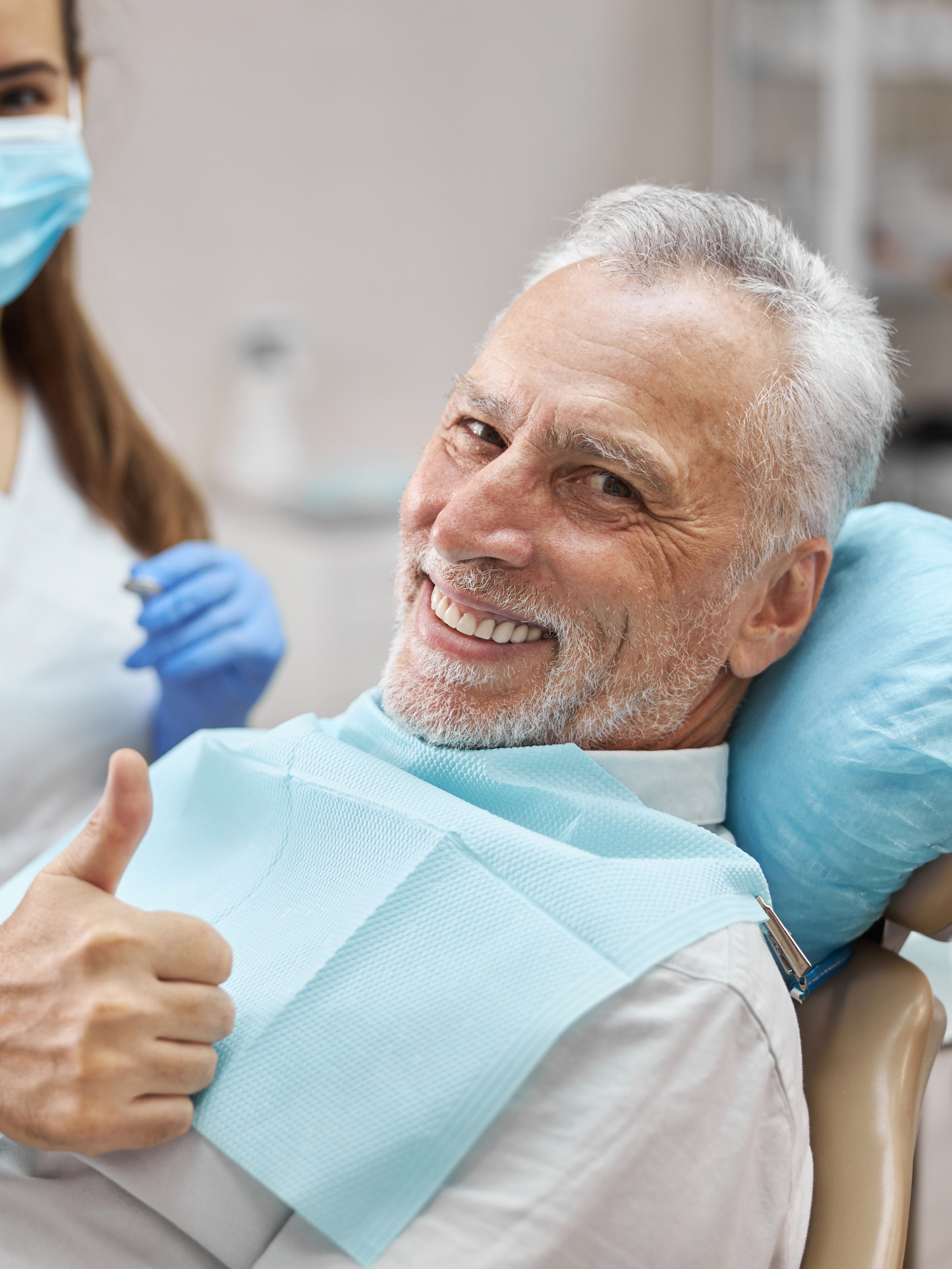 A dentist and a senior male patient discussing and undergoing a dental implants process for in Baton Rouge, LA