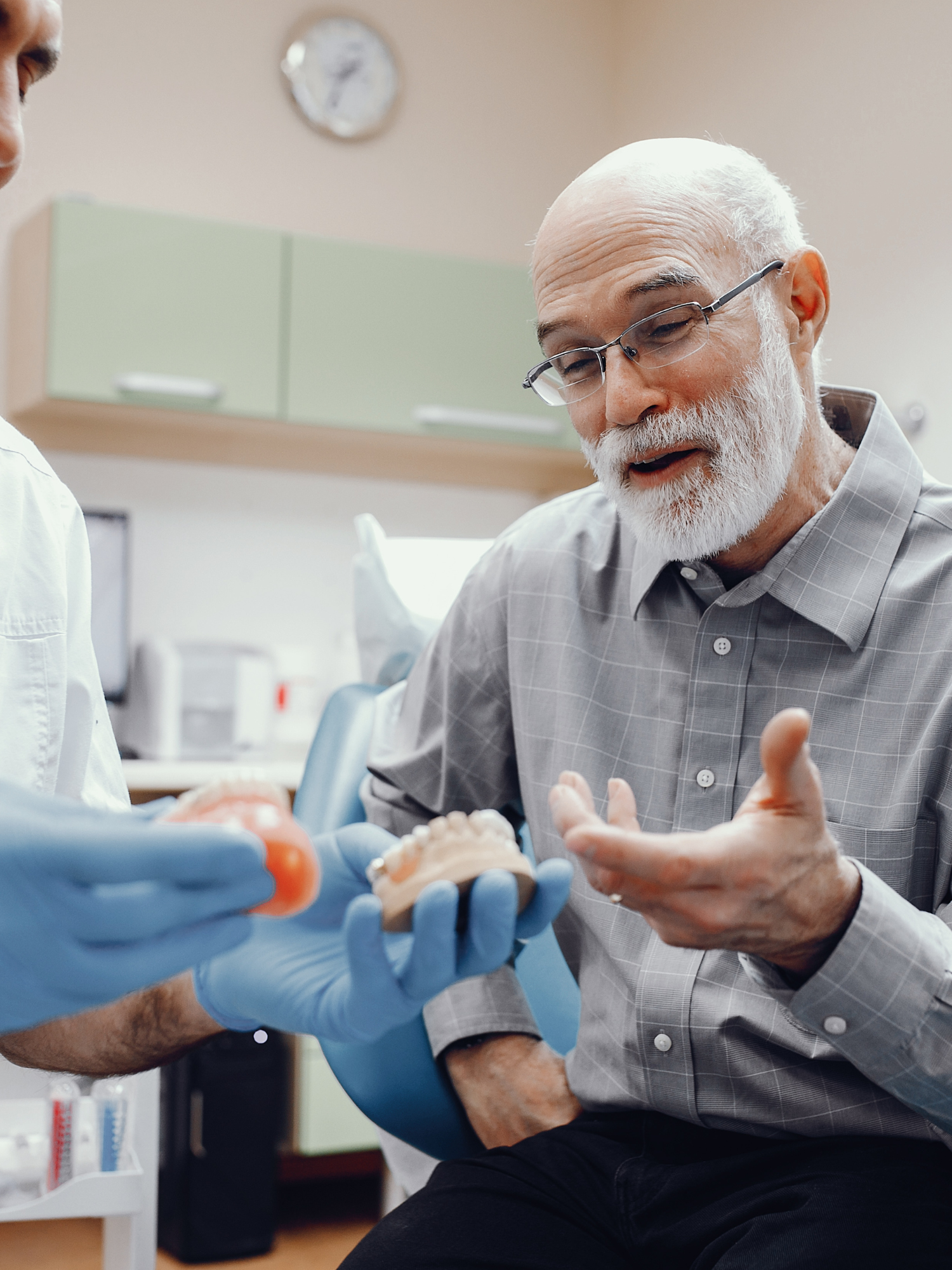 A dentist and a senior patient discussing and undergoing a dental implants process for in Baton Rouge, LA