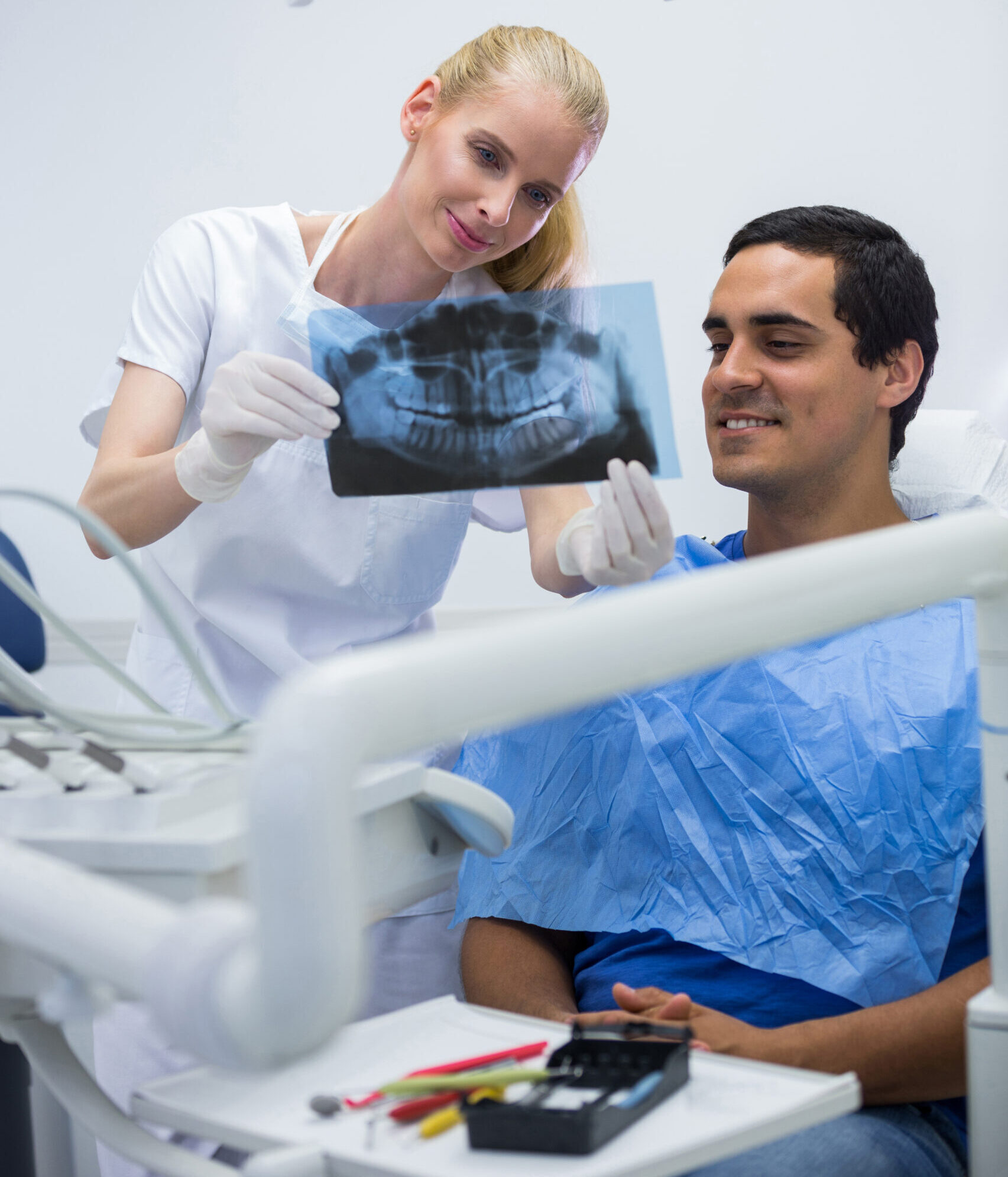A doctor briefing a patient about full-mouth dental implants in Denham Springs, LA